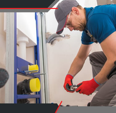 a man in a blue shirt and red gloves is holding a wrench