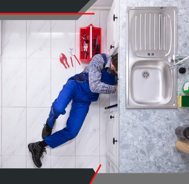 a plumber in a kitchen with a sink and a sink