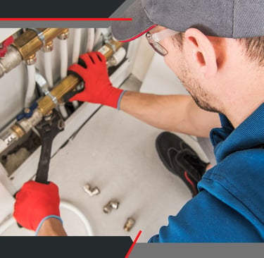 a plumber in a blue shirt and red gloves