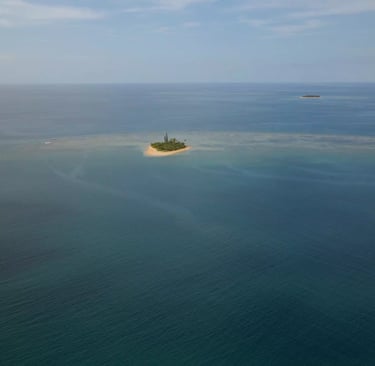 a small island with a small island in the middle of the ocean