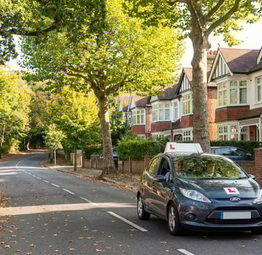 Learner driver navigating a hill during driving lessons in Loughton