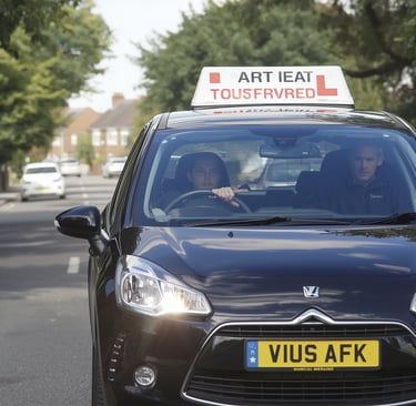 Learner driver in Woodford taking a lesson with a patient driving instructor.