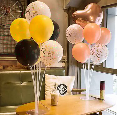 Festive balloon centerpieces adding charm to 1st birthday party tables.