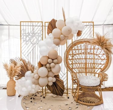 Adorable balloon garland draped around the high chair, perfect for a 1st birthday celebration.