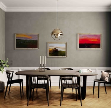 Modern dining room with a dark wood table, gold pendant light, and paintings on grey walls.