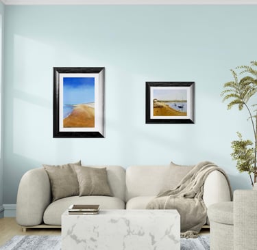 Modern living room featuring coastal wall art above a beige sofa and marble coffee table.
