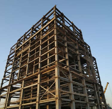 a large building with a crane in the background