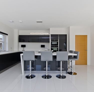 Custom kitchen in East Kilbride showcasing modern cabinets, a large island and bar seating