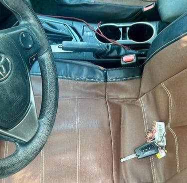 Car key locked inside of vehicle on seat—  representing emergency locksmith by Asheville Locksmith Now 