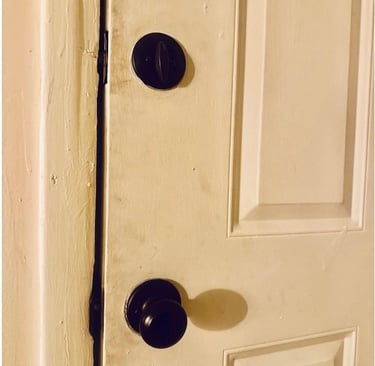 White door with deadbolt representing residential locksmith services including rekeying, key copy, and smart locks