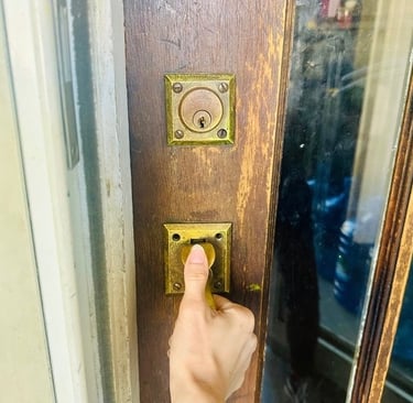Hand on home door during lockout— representing emergency residential service locksmith in Candler, NC