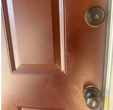 Red home door with deadbolt and knob representing residential locksmith services Candler, NC 