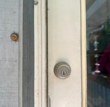 White door with deadbolt representing residential locksmith services in Canton, NC