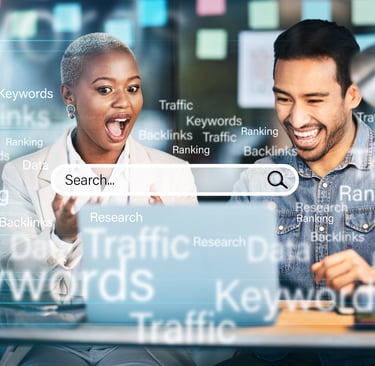 a man and woman looking at a laptop computer screen