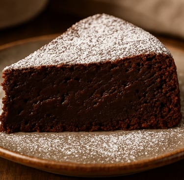 a piece of cake on a plate with powdered sugar on top