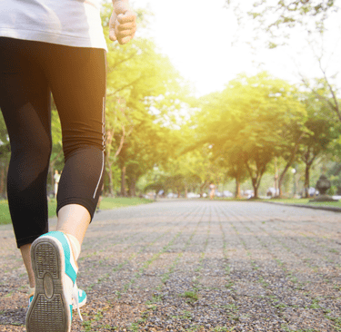 a woman running on a path in the park