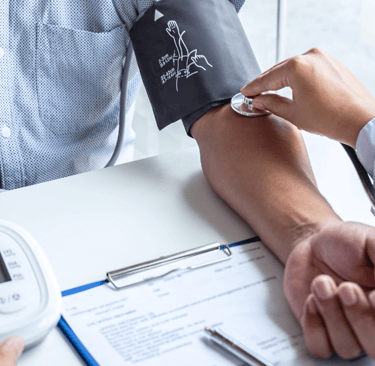a doctor checking a patient's blood pressure