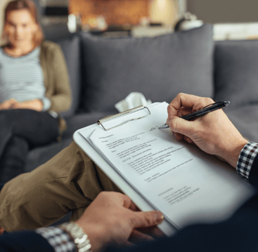 a man and woman sitting on a couch in a living room