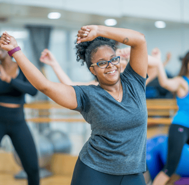 a woman in a gray shirt and black pants