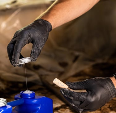 Caleb Smith using PVC glue to reroute PVC pipes