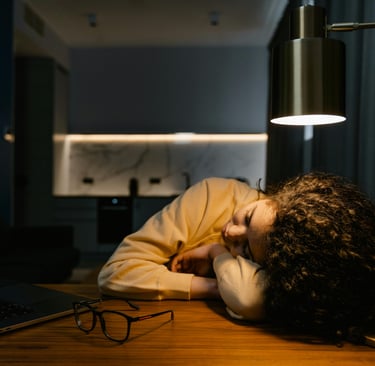 Tasha sleeping at the table, after a night of researching the best ways to make money from home.