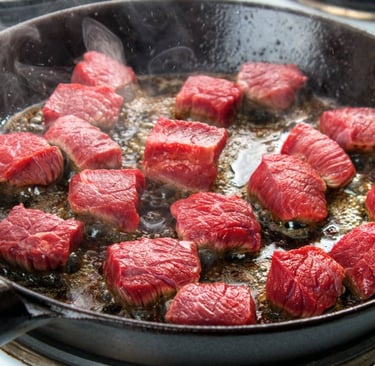 Grass Fed beef cooking in skillet
