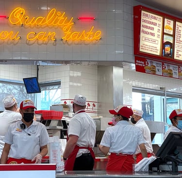 Busy fast food restaurant with customers in line at the counter