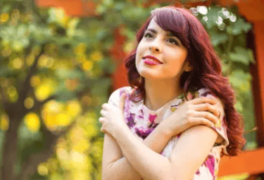 a woman with red hair and a pink dress
