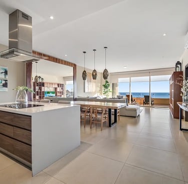 Modern luxury penthouse kitchen and open-concept living area with ocean views in Los Cabos