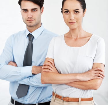 a man and woman standing in front of a white wall