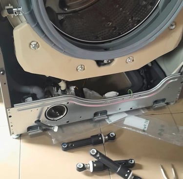 LG front load washer with base panel removed for damper replacement to resolve excessive vibration d