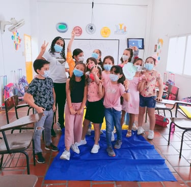 a group of children and the teacher in a classroom