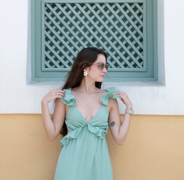 young woman in turquoise dress and sunglasses
