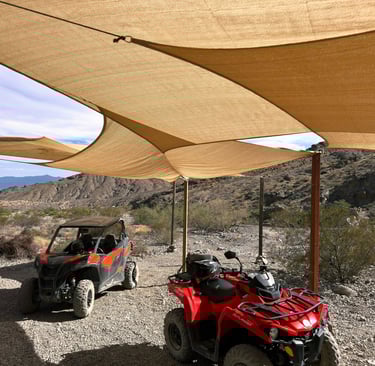 two atvs parked in a desert area