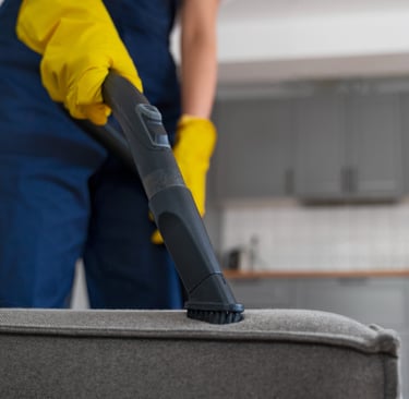 KLEAN WELL professional deep cleaning a couch to remove dust, allergens, and hidden dirt
