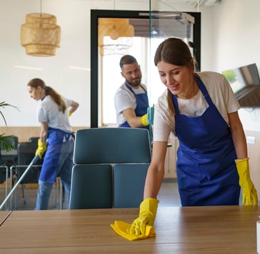 KLEAN WELL team member cleaning a modern living room with attention to detail