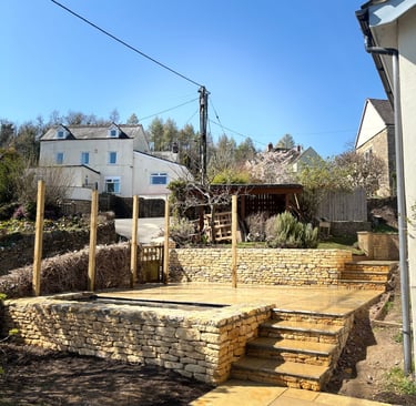 Custom designed garden project with dry stone retaining walls, steps, and patio