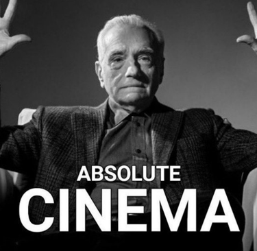An older man in a suit and tie, sitting in an armchair with his hands up and highlighting the frese