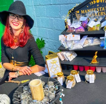 a woman in a witch hat at a market booth
