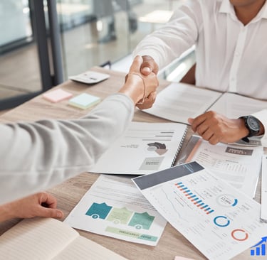 Two professionals cshaking hands after closing a deal