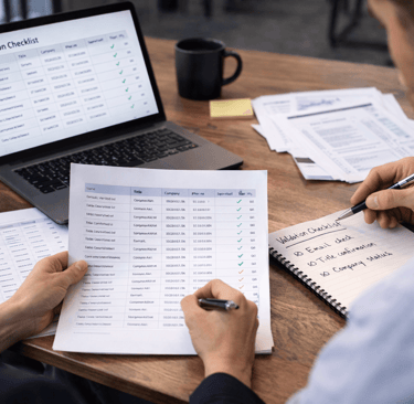 Analysts reviewing contact data and validation checklist at desk