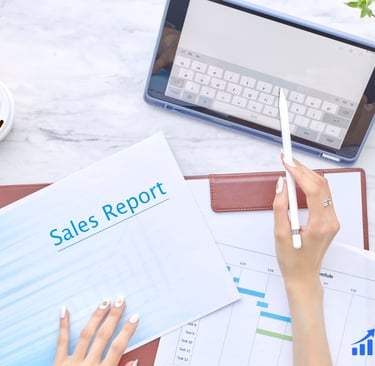 Hands reviewing a sales report at a clean office desk