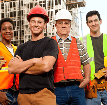 Construction workers in safety gear at an active building site