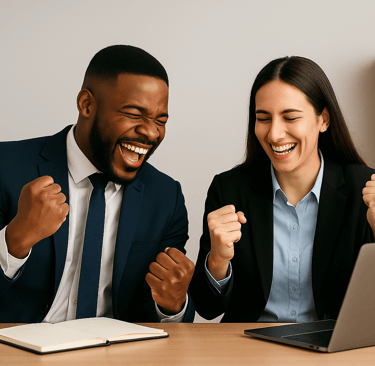 Two founders celebrating outbound wins at a desk