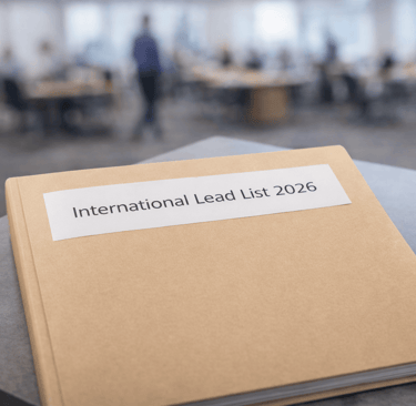 Binder labeled International Lead List 2026 on office table