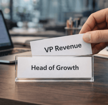 desk nameplate showing role change from head of growth to vp revenue