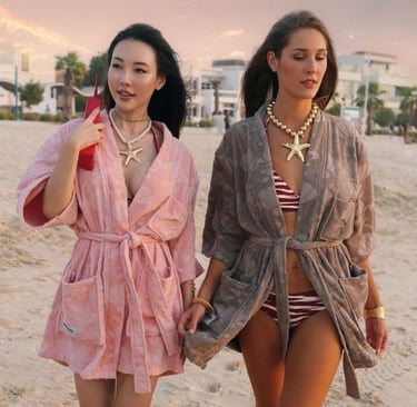Women walking comfortably wearing Mermaids Club beach robes with secure fit.