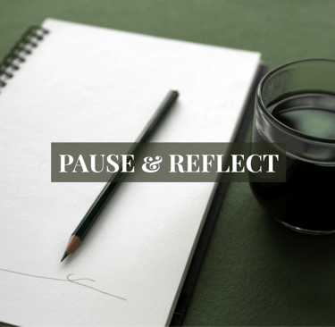 a cup of coffee and a pencil on a notebook