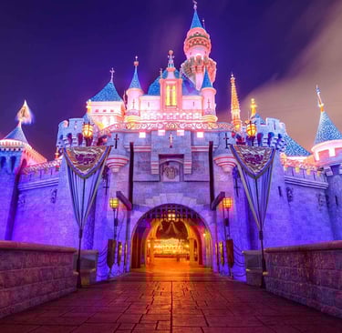 Sleeping Beauty Castle at Disneyland glowing at night - The heart of late-night mischief
