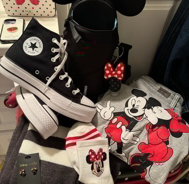 Adult Disney gear with backpack, Mickey and Minnie sweatshirt, and Minnie socks